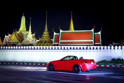 Vintage car on illuminated building at night