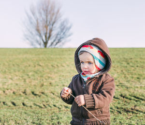 Portrait of boy on field during winter