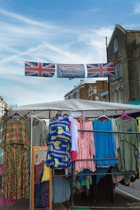Colorful women's dresses displayed in a stand in portobello road, london.