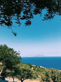 Scenic view of sea against clear blue sky