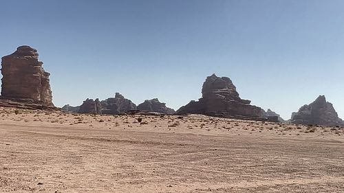 Rock formations on landscape against clear sky