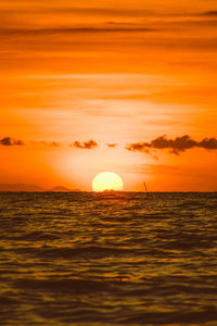 Scenic view of sea against orange sky