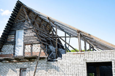 Unfinished construction and building of a brick diy house with a wooden roof with your own hands