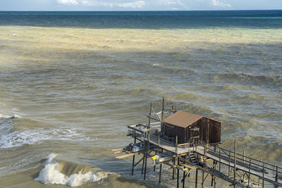 High angle view of beach by sea against sky