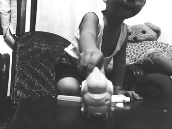 Midsection of woman sitting on sofa at home