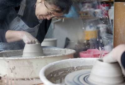 Woman using potters wheel