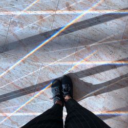 Low section of person standing on tiled floor