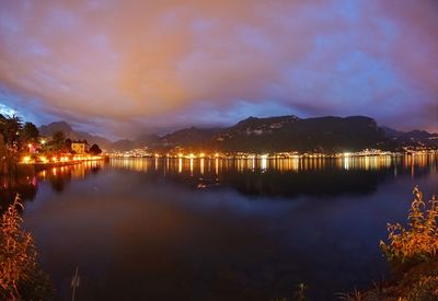 Scenic view of lake against sky at night