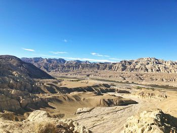 Scenic view of mountains against blue sky