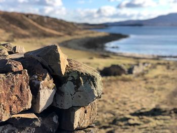 Stack of rocks on land against sky