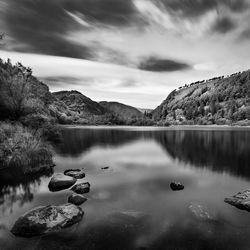 Scenic view of lake and mountains against sky