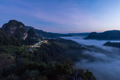 High angle view of trees and mountains against sky at sunset