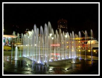 Illuminated fountain at night