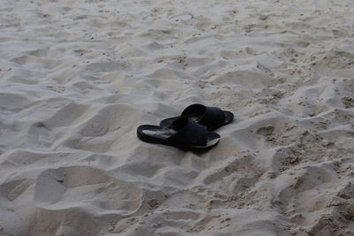 High angle view of footprints on sand at beach