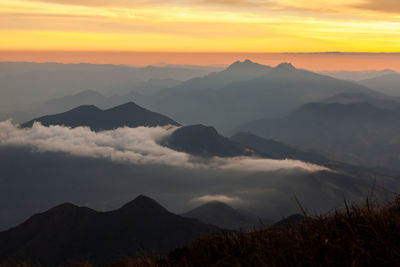 Scenic view of silhouette mountains against sky during sunset