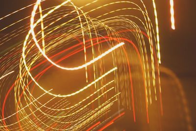 Close-up of light trails against sky at night