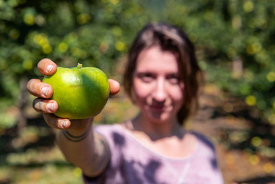 Portrait of smiling man holding apple