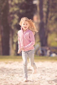 Portrait of girl running at park