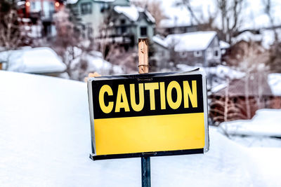 Close-up of sign on snow covered road