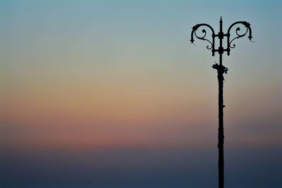 Low angle view of silhouette pole against sky during sunset