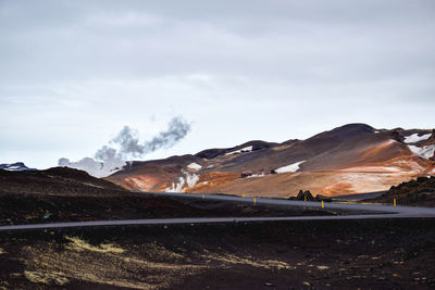 Scenic view of mountains against cloudy sky