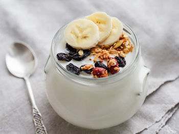 Natural homemade yogurt in glass jar. healthy food for breakfast with muesli. jar with granola