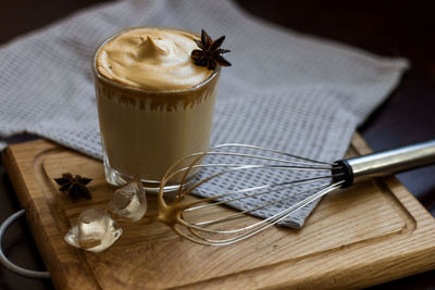 A glass of the popular trendy drink dalgona coffee with milk. whisk and ice. high quality photo