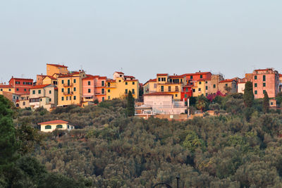 Buildings in city against clear sky