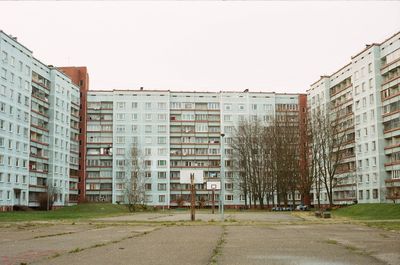 Buildings in city against clear sky