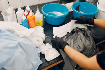 Midsection of woman cleaning garbage