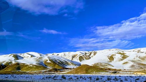 Scenic view of snowcapped mountains against sky