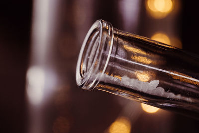 Close-up of salt in glass bottle