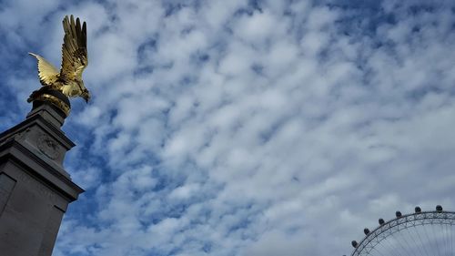 Low angle view of church against cloudy sky