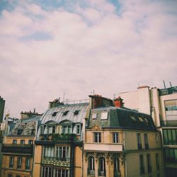 Low angle view of building against cloudy sky