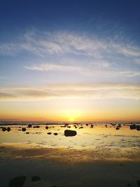 Scenic view of beach against sky during sunset