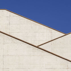 Low angle view of building against clear blue sky