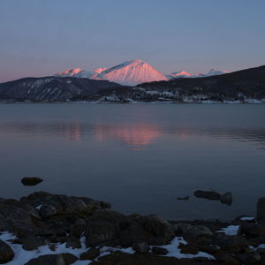 Scenic view of lake and mountains against sky