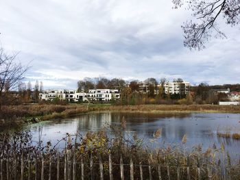 Scenic view of lake by building against sky