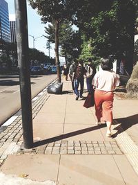 People walking on sidewalk in city