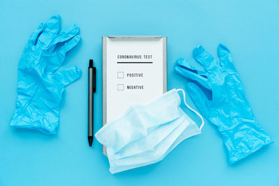 High angle view of text on paper against blue background