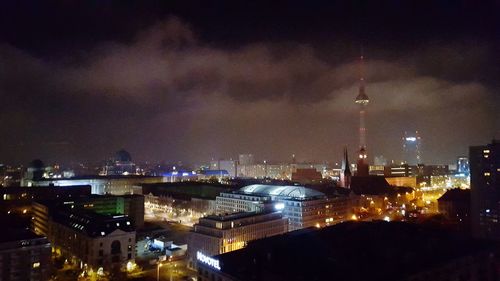 Aerial view of city lit up at night