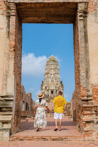Ayutthaya, thailand at wat ratchaburana, couple men and women with a hat visiting ayyuthaya thailand