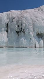 Scenic view of frozen sea against sky during winter