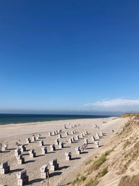 Scenic view of beach against clear blue sky