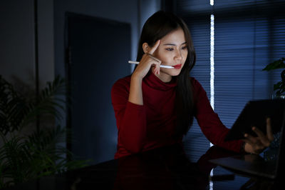 Portrait of young woman using mobile phone