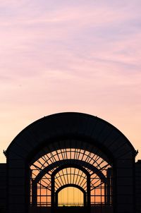 Low angle view of silhouette building against sky during sunset