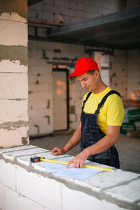 Rear view of man working at construction site