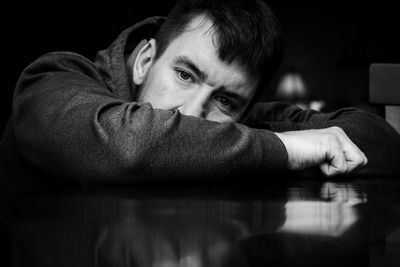Close-up portrait of young man relaxing on table