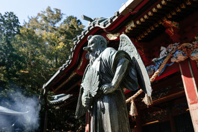 Low angle view of statue against building