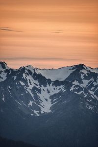 Scenic view of snowcapped mountains against sky during sunset